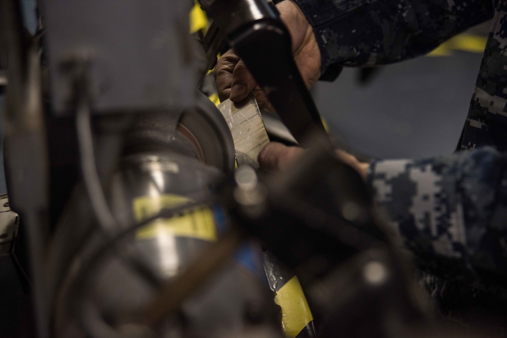 Sailor grinds metal.