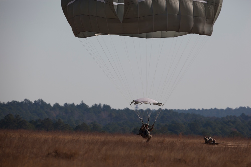 U.S Army Paratroppers landing after completing their jump in participation for the 20th Annual Randy Oler Memorial Operation Toy Drop, hosted by U. S. Army Civil Affairs &amp; Psychological Operations Command (Airborne), Dec. 01, 2017 on Sicily Drop Zone at F