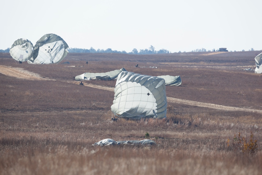 U.S Army Paratroppers landing after completing their jump in participation for the 20th Annual Randy Oler Memorial Operation Toy Drop, hosted by U. S. Army Civil Affairs &amp; Psychological Operations Command (Airborne), Dec. 01, 2017 on Sicily Drop Zone at F