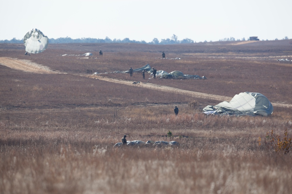 U.S Army Paratroppers landing after completing their jump in participation for the 20th Annual Randy Oler Memorial Operation Toy Drop, hosted by U. S. Army Civil Affairs &amp; Psychological Operations Command (Airborne), Dec. 01, 2017 on Sicily Drop Zone at F