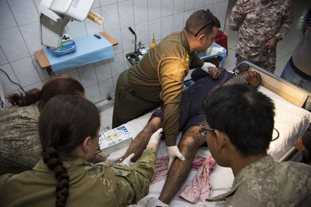 Iraqi medical staff member with Coalition support provide medical care at Taji