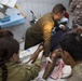 Iraqi medical staff member with Coalition support provide medical care at Taji