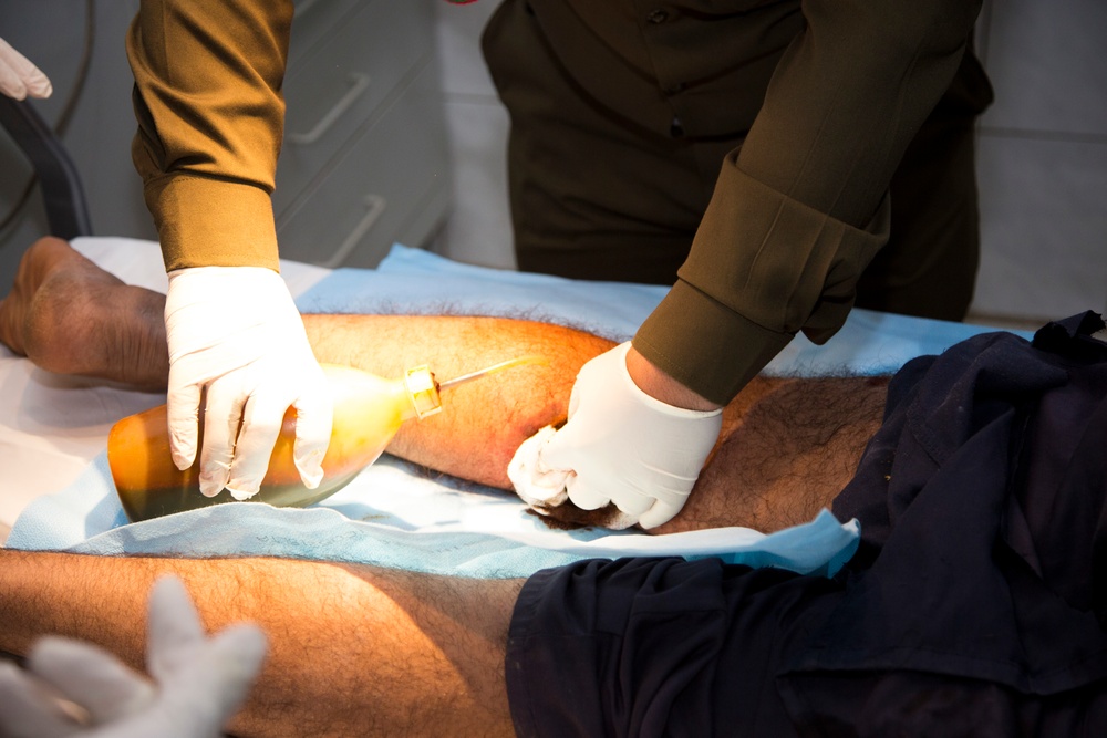 Iraqi medical staff member with Coalition support provide medical care at Taji