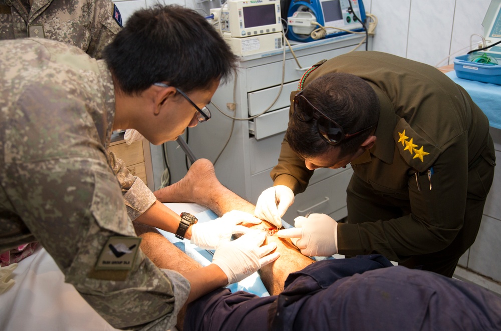 Iraqi medical staff member with Coalition support provide medical care at Taji