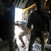 Joint crew of U.S and Swedish jumpmasters prepare to shut the doors of a U.S. Air Force C-130 Hercules after fifty-four paratroopers exited the plane