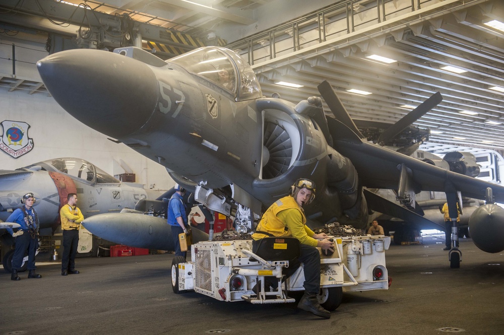 USS America Sailor tows AV-8B Harrier to hangar bay