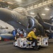 USS America Sailor tows AV-8B Harrier to hangar bay