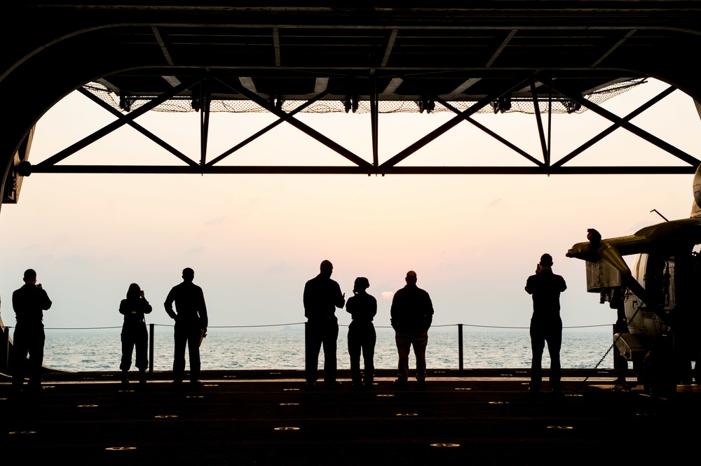 Sailors and Marines lookout to the sunset