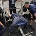Blue Ridge Sailors celebrate the reopening of the ships gym during a Bench Press Competition.