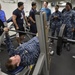 Blue Ridge Sailors celebrate the reopening of the ships gym during a Bench Press Competition.