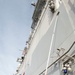 USS America sailor paints the side of the ship