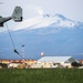 Marines fast rope in front of volcano