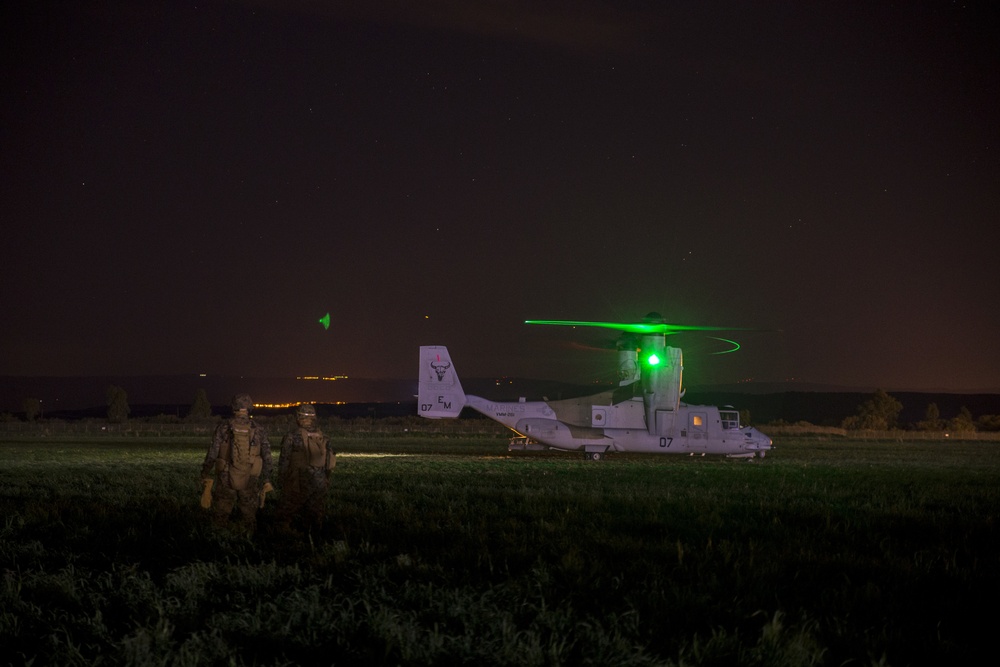 Marines fast rope in front of volcano
