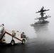 USS Abraham Lincoln Sailors stand ready