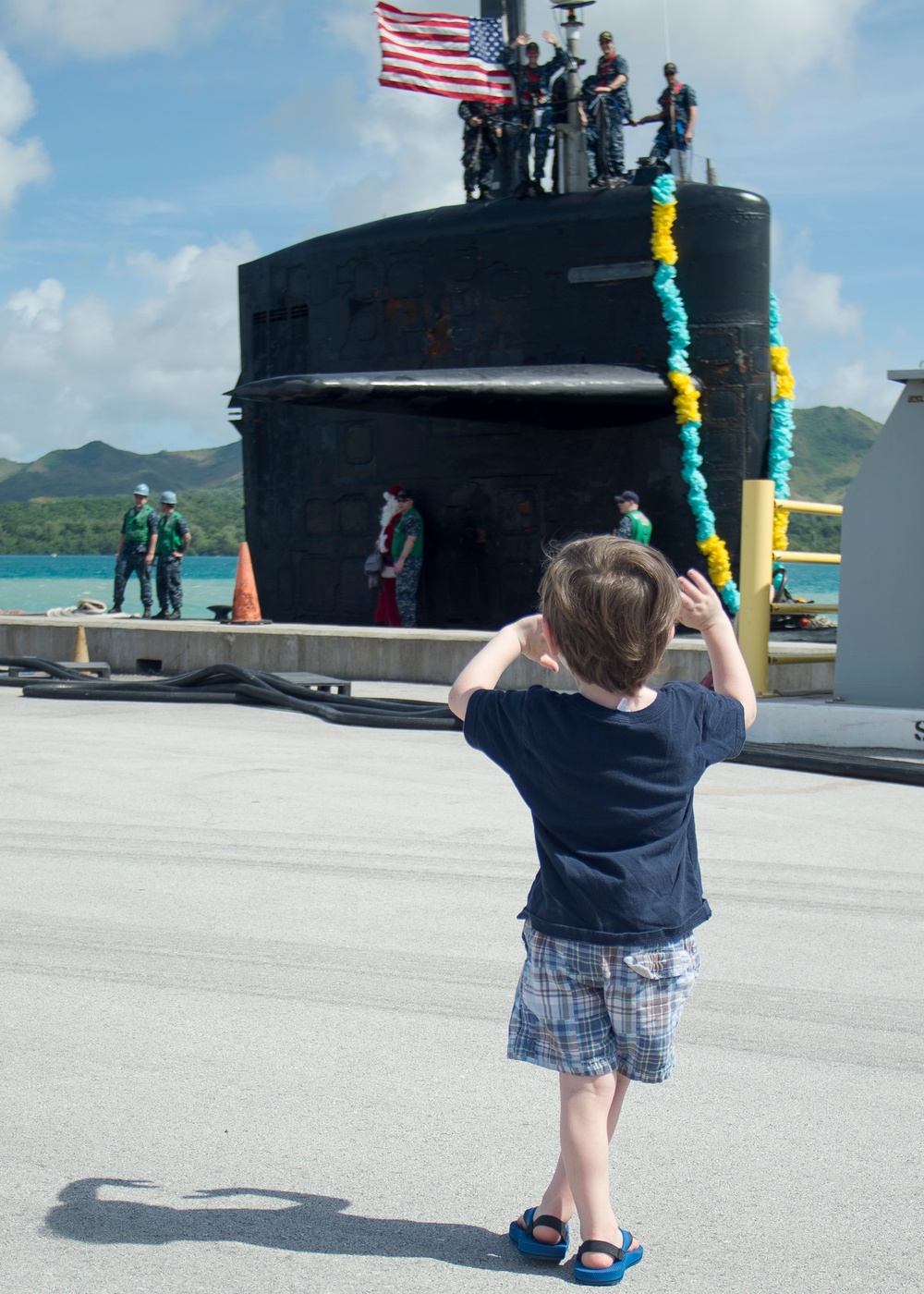 Child Waves to Father During USS Key West Return to Homeport Dec. 15