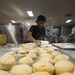 15th MEU Marine works in the bake shop on USS America