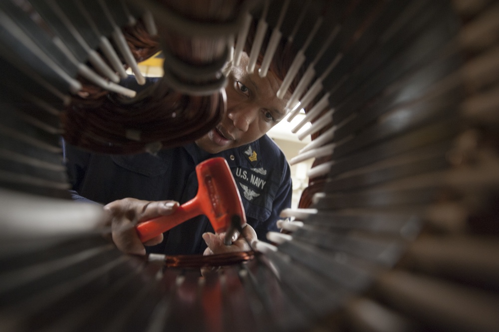 USS America Sailor installs wiring in compressor motor