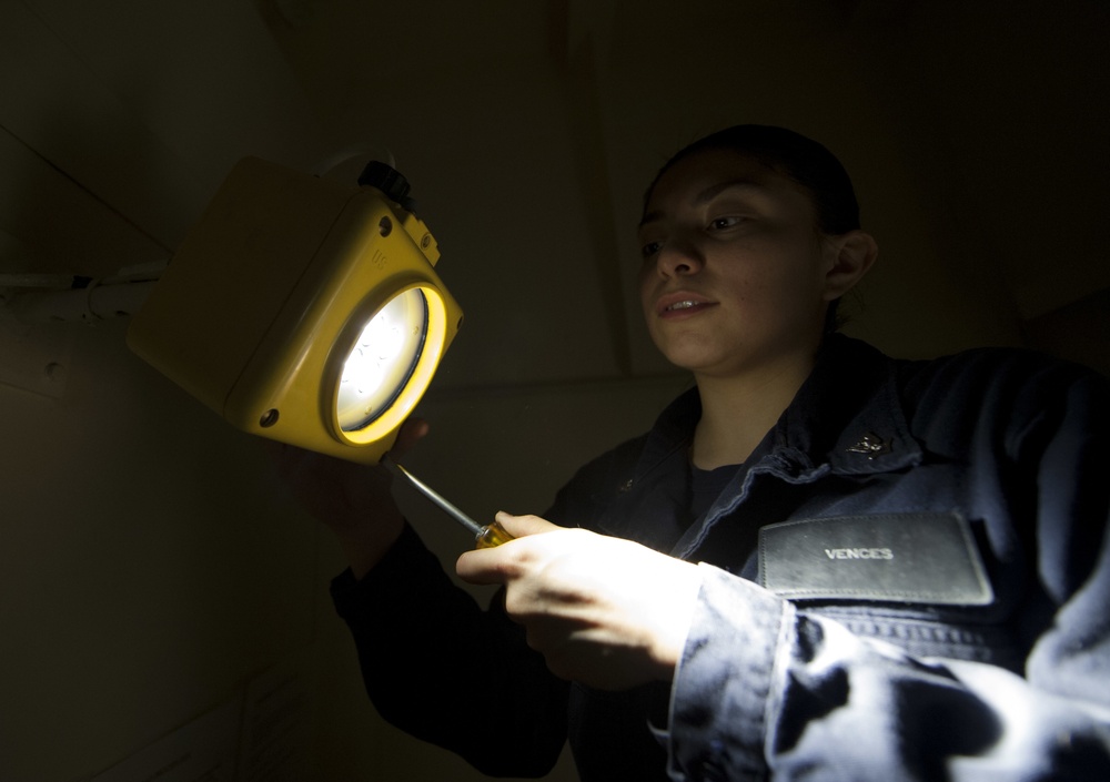 USS America Sailor fixes battle lantern