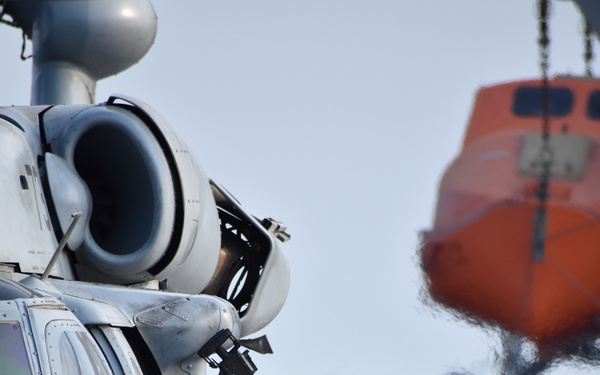 U.S. Navy Aviation Boatswains Mate Fuel (ABF) Sailors refuel an MH-60 Helicopter aboard USS Lewis B. Puller