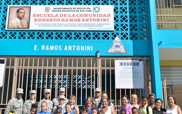 Airmen from the 156th Airlift Wing distribute food to local area children’s schools