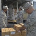 Airmen from the 156th Airlift Wing distribute food to local area children’s schools