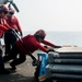 America Sailors handle ordnance