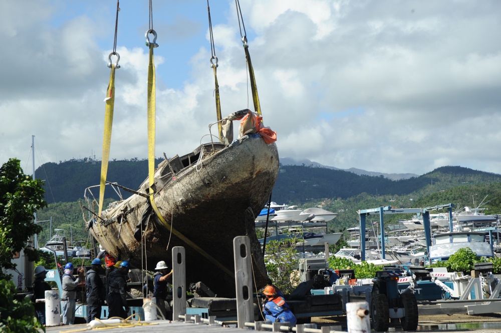 Hurricane response crews in Puerto Rico move wrecked vessel off crane barge