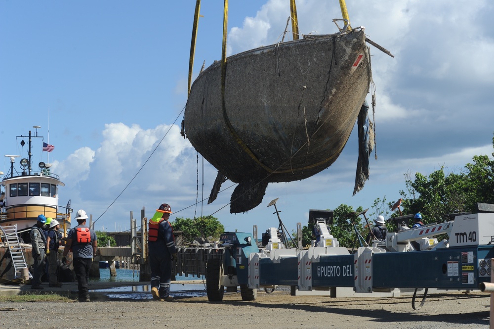 Hurricane response crews in Puerto Rico move wrecked vessel off crane barge