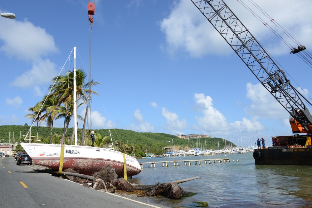 Hurricane Maria salvage crews remove wrecked boat from road in Fajardo, Puerto Rico