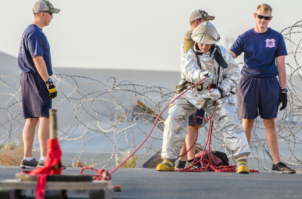 Airman participate in a firefighter combat challenge