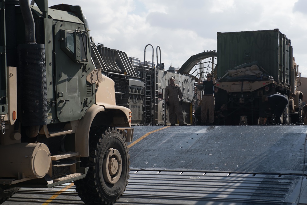 USS Pearl Harbor Sailors backload equipment