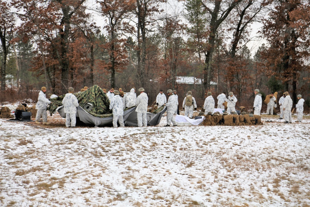 Cold-Weather Operations Course 18-01 students, all Marines, practice tentbuilding at Fort McCoy