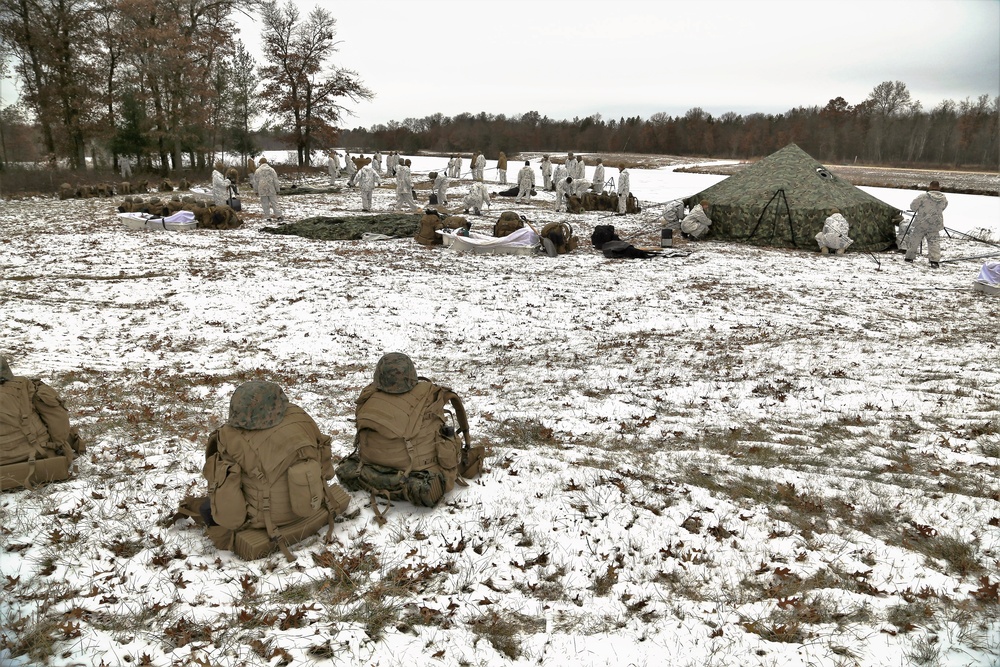 Cold-Weather Operations Course 18-01 students, all Marines, practice tentbuilding at Fort McCoy