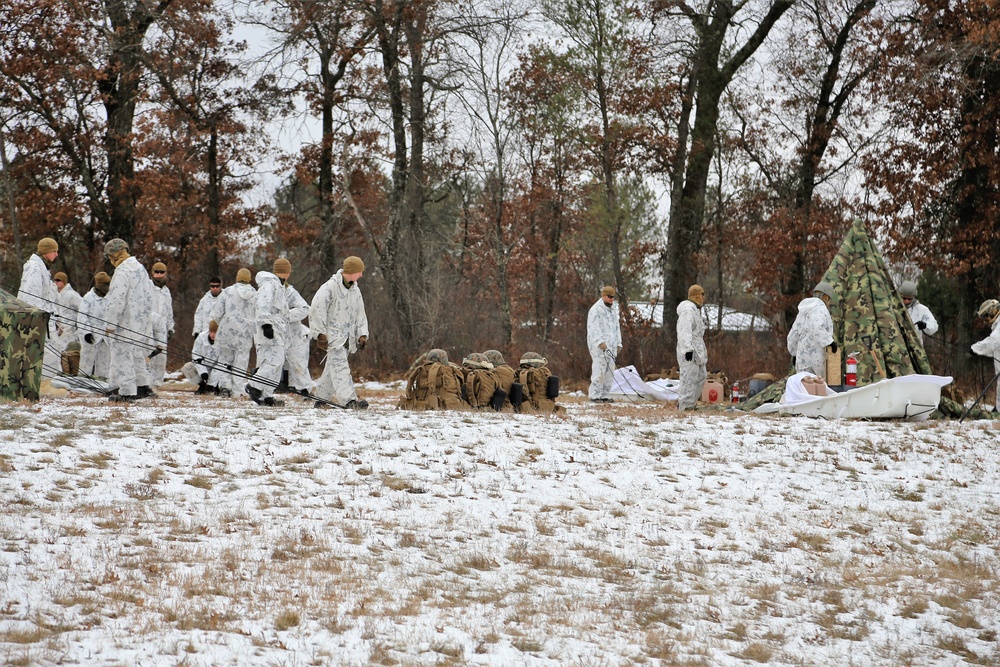 Cold-Weather Operations Course 18-01 students, all Marines, practice tentbuilding at Fort McCoy