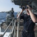 USS America (LHA 6) Sailor stands aft lookout on the fantail