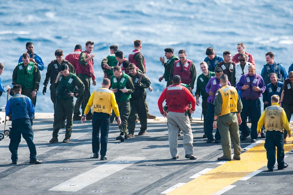 USS America (LHA 6) Sailors and Marines participate in FOD walkdown before flight quarters