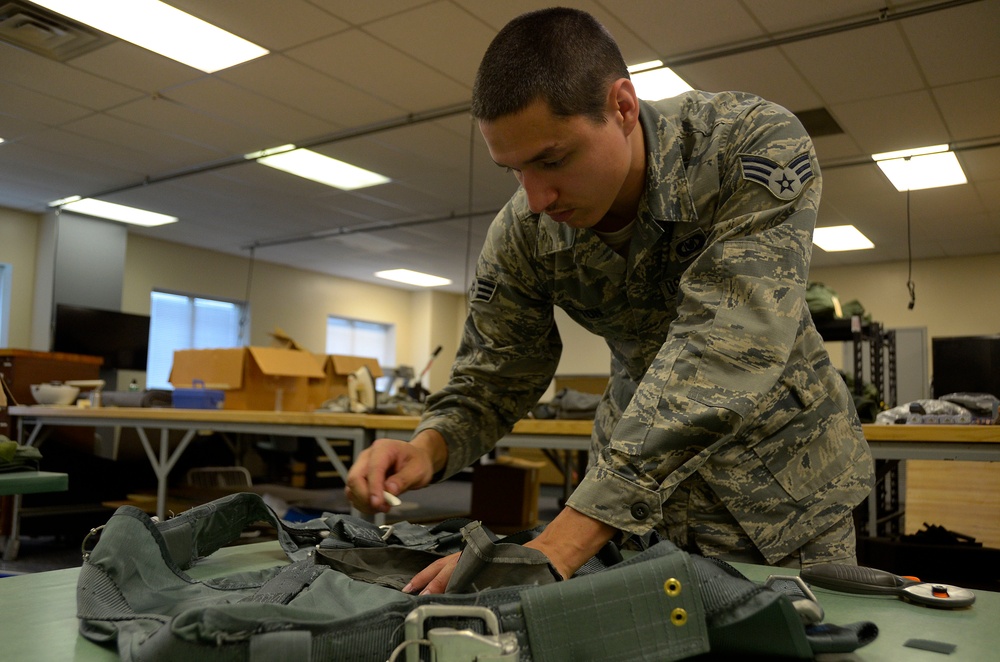 Aircrew flight equipment Airman sews for a living