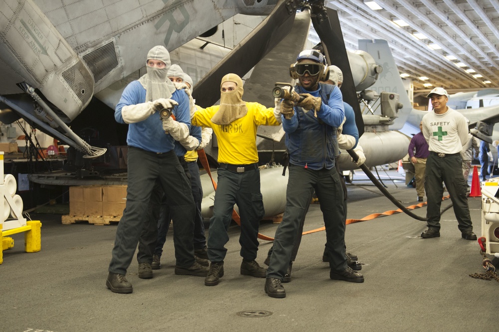 USS America Sailors participate in fire drill in the hangar bay