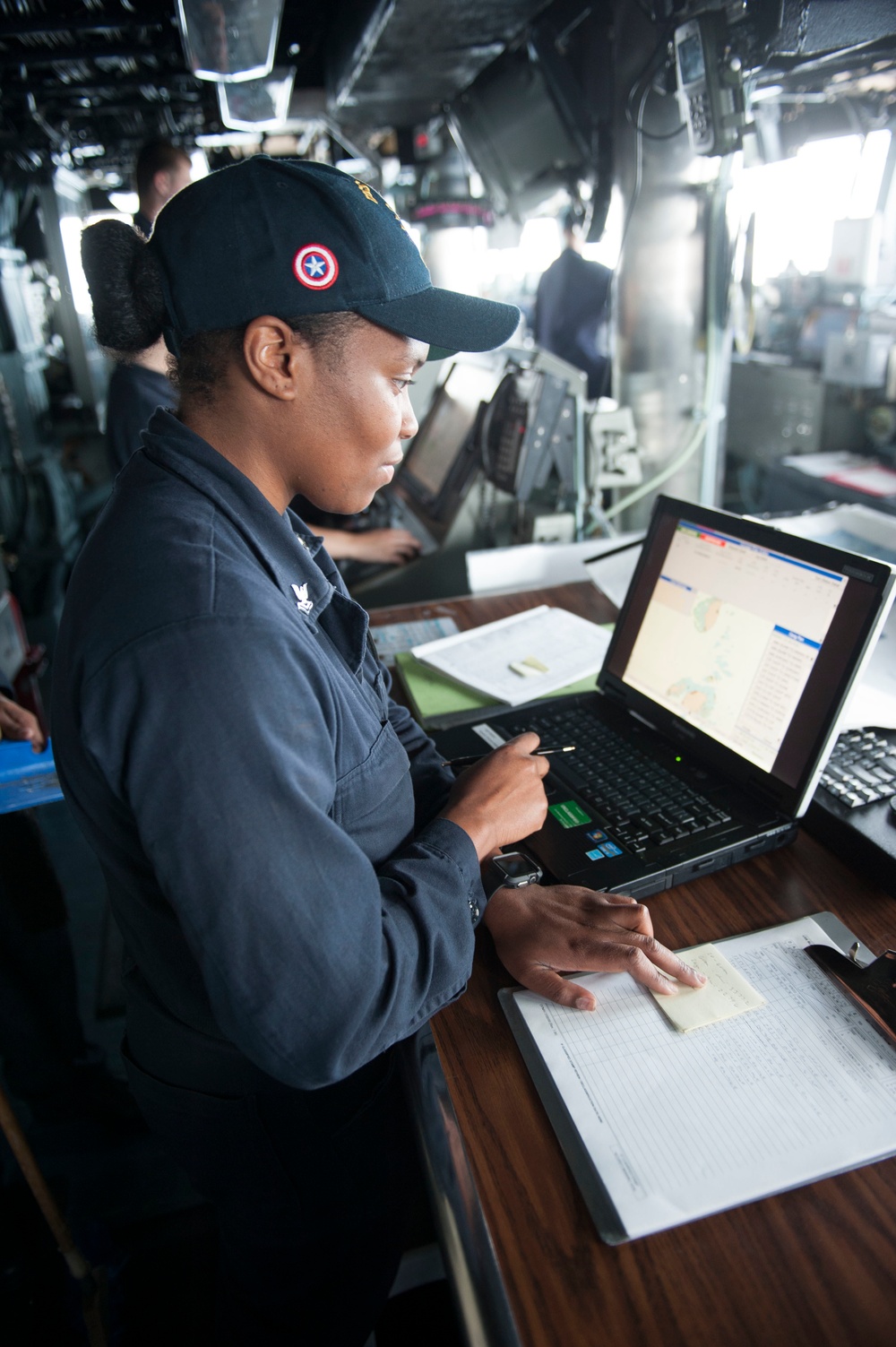 USS America (LHA 6) Sailor stands quartermaster of the watch on the bridge