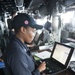 USS America (LHA 6) Sailor stands quartermaster of the watch on the bridge