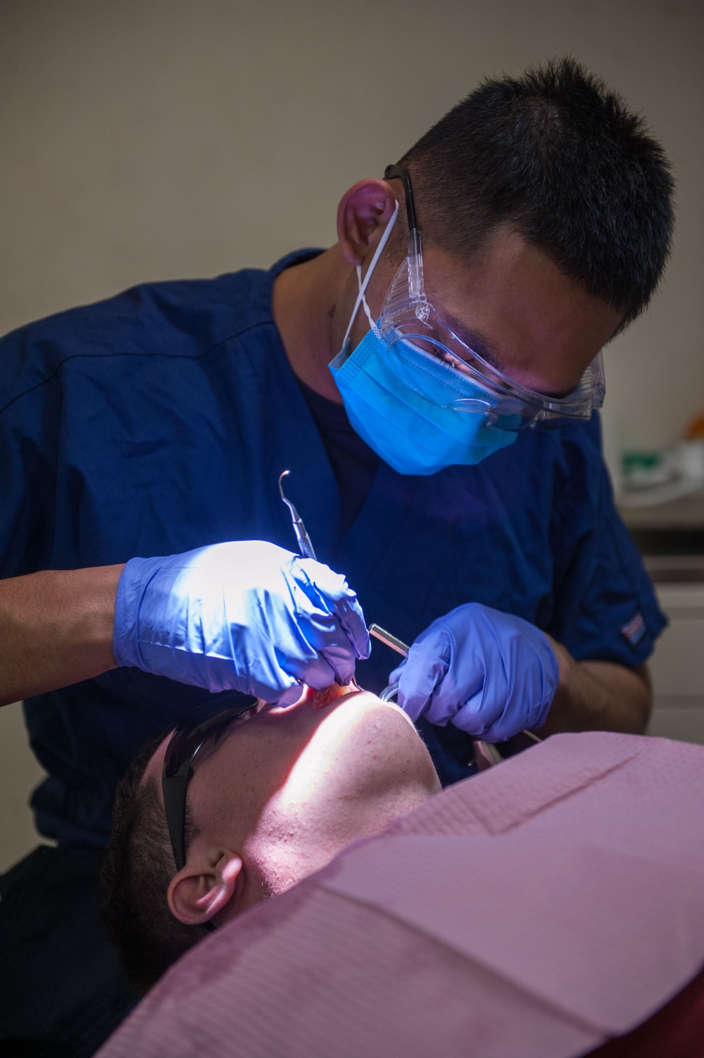 America Sailor does cleaning on a patient