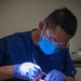 America Sailor does cleaning on a patient