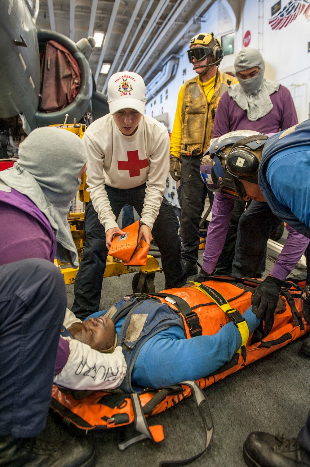 USS AMerica Sailor directs Sailors on casualty procedures