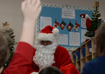Santa flies with 28th OG giving gifts to families