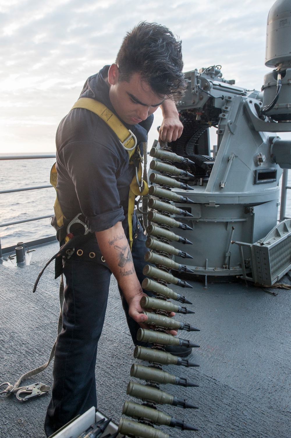 USS AMerca Sailors readies ammo for live fire exercise