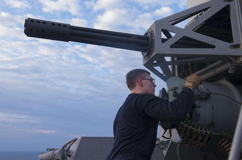 USS America (LHA 6) Sailors inspects CIWS