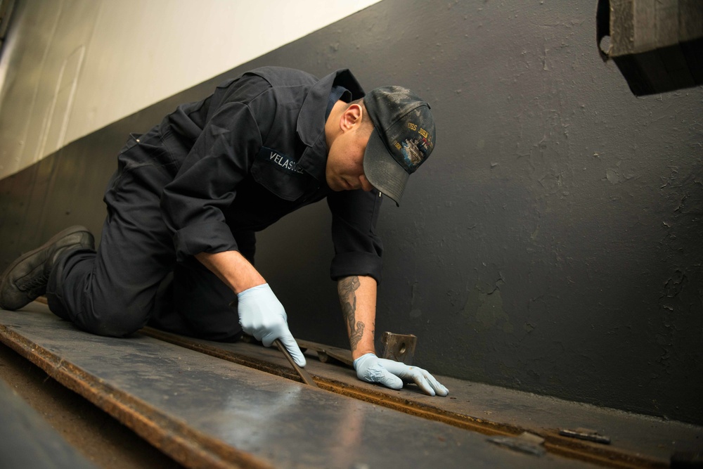 John C. Stennis Sailor Performs Maintenance in Hangar Bay