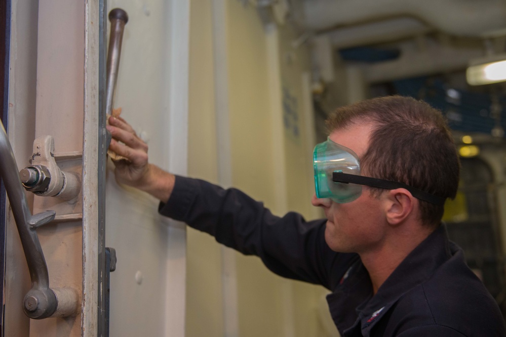 John C. Stennis Sailor Performs Maintenance on a Hatch