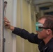 John C. Stennis Sailor Performs Maintenance on a Hatch