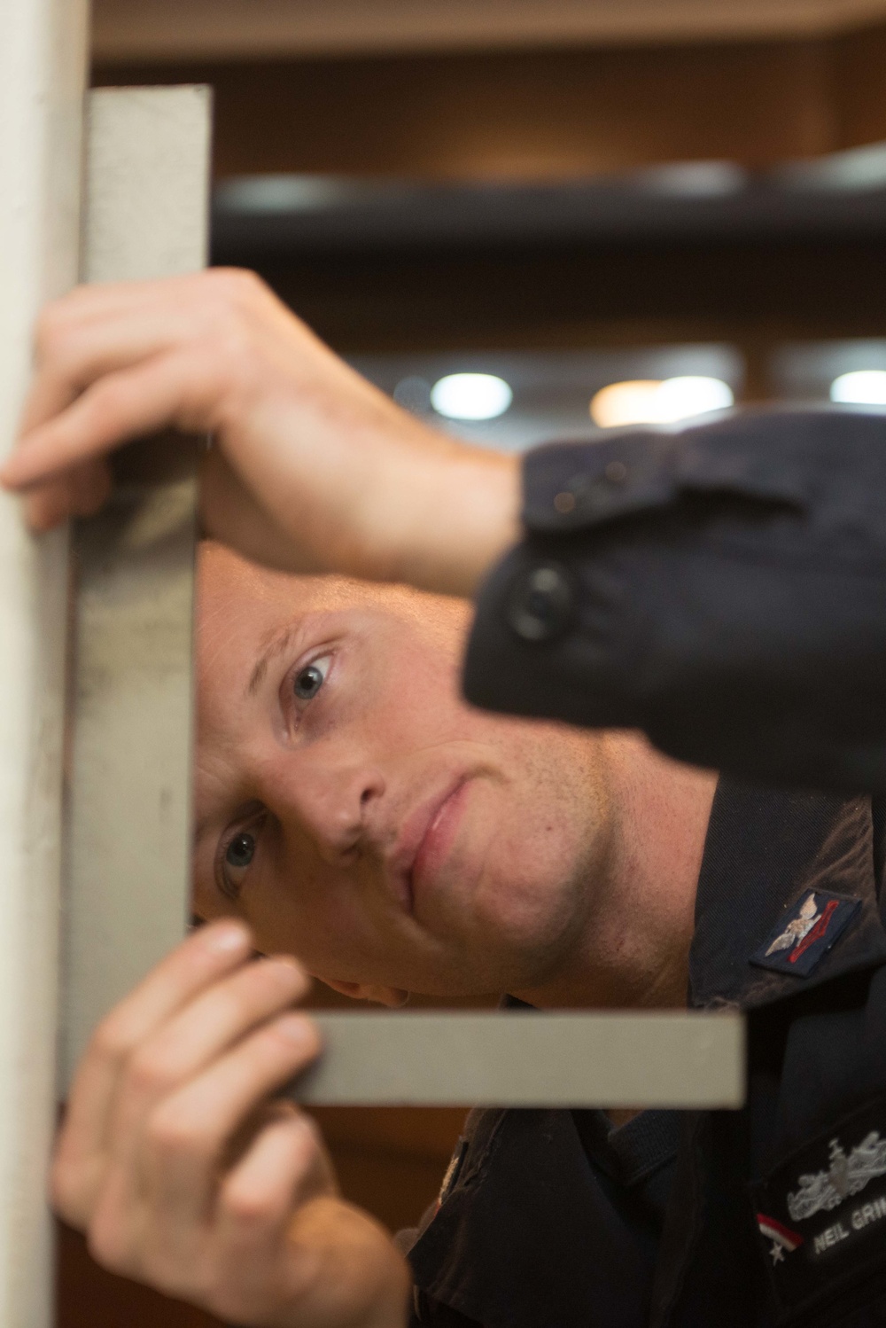 John C. Stennis Sailor Performs Maintenance on a Hatch